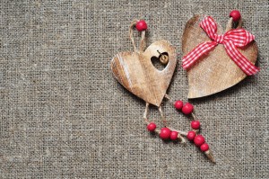 Wooden hearts on fabric background